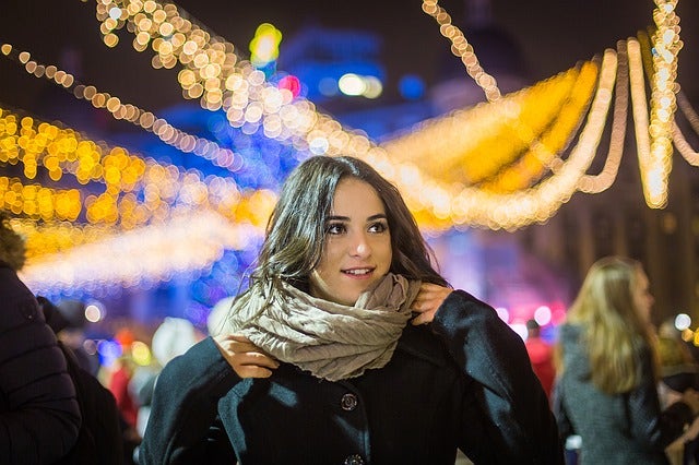 Woman standing in front of fairy lights