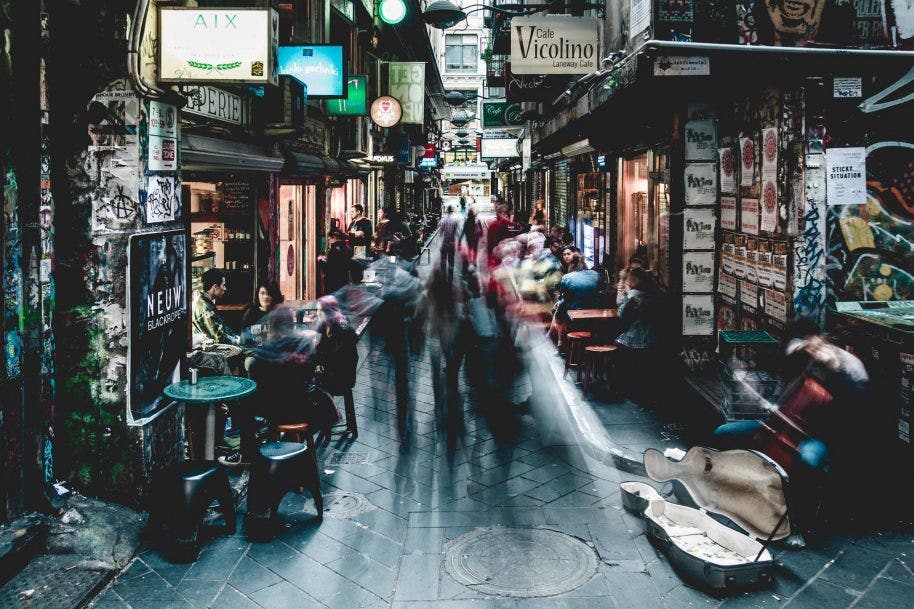 people passing through a narrow Melbourne alley