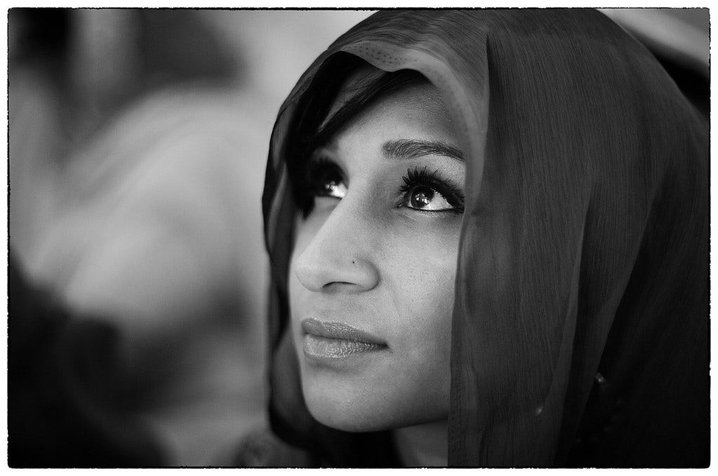 a woman with scarf looking up