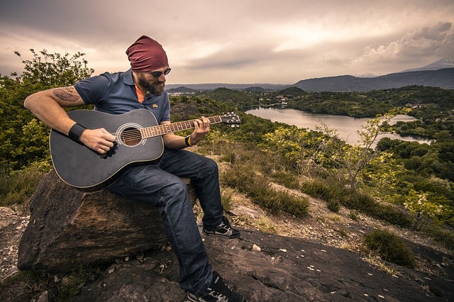 guitarist on mountaintop