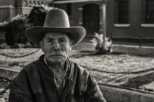 man with fedora on street