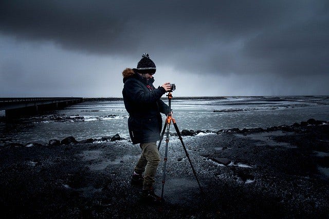 photographer with tripod at beach