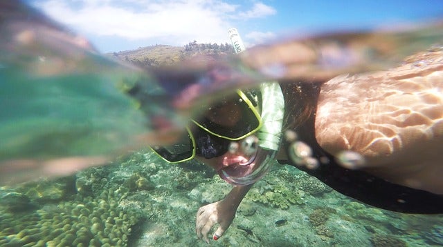 Person with an action camera while snorkelling