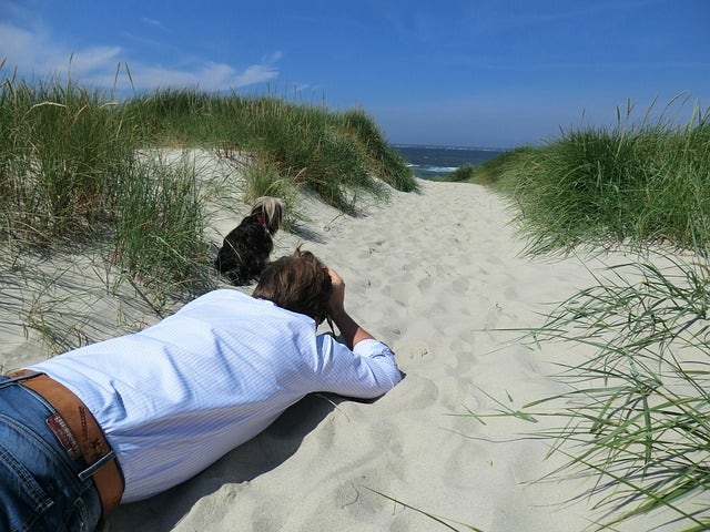 A man taking a photo in the sand