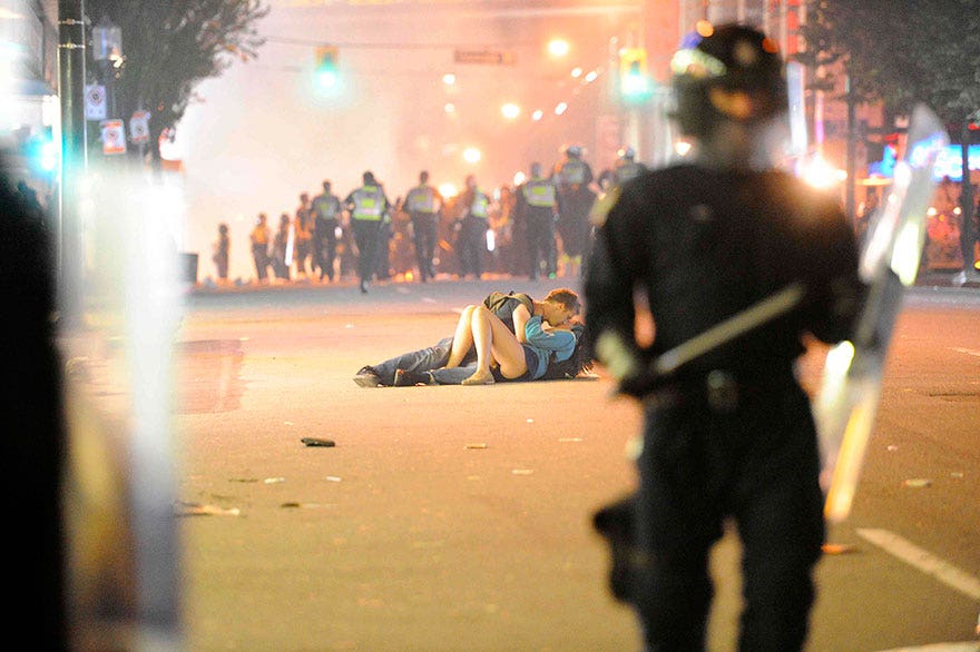 couple-kiss-on-ground-amidst-riot-police