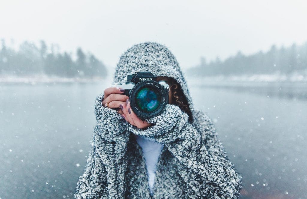 girl-takes-photo-in-snow