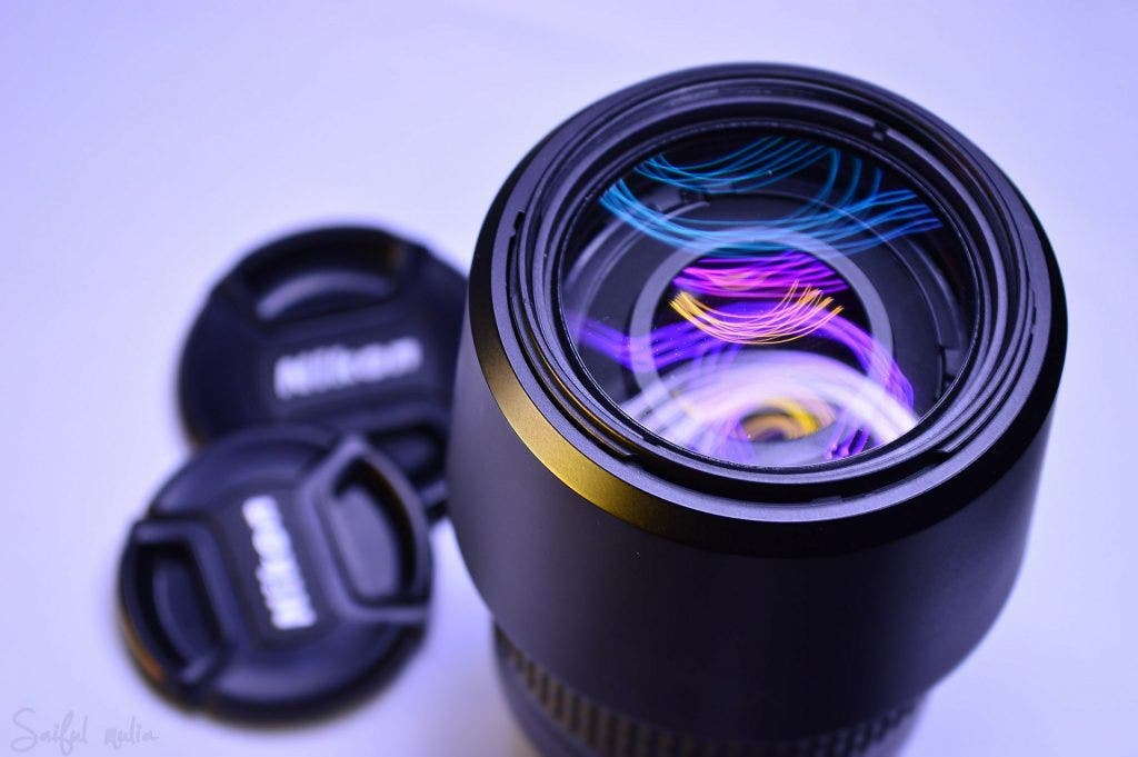 neon-lit-image-of-nikon-camera-lens-and-hood