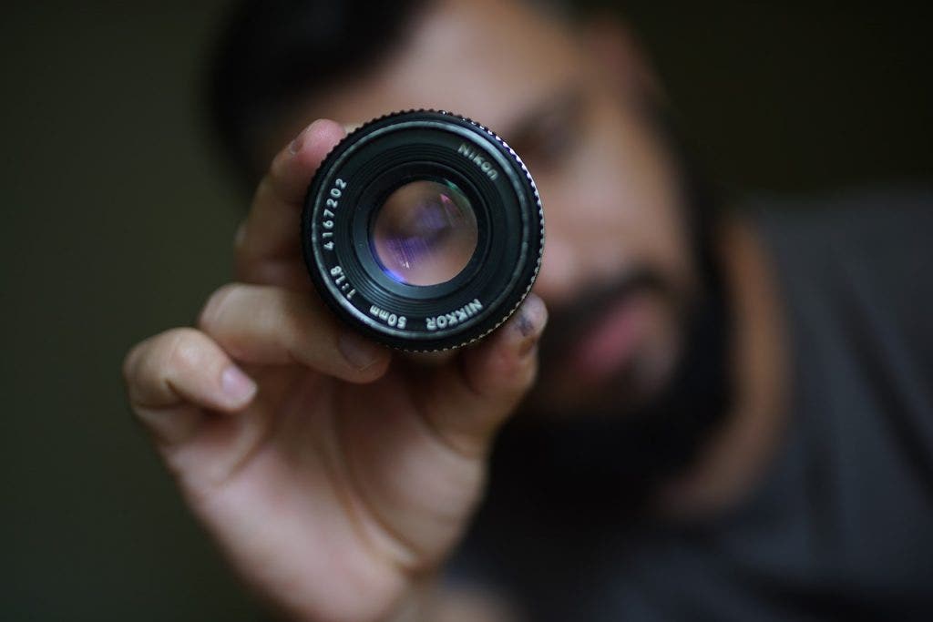 man holding prime lens