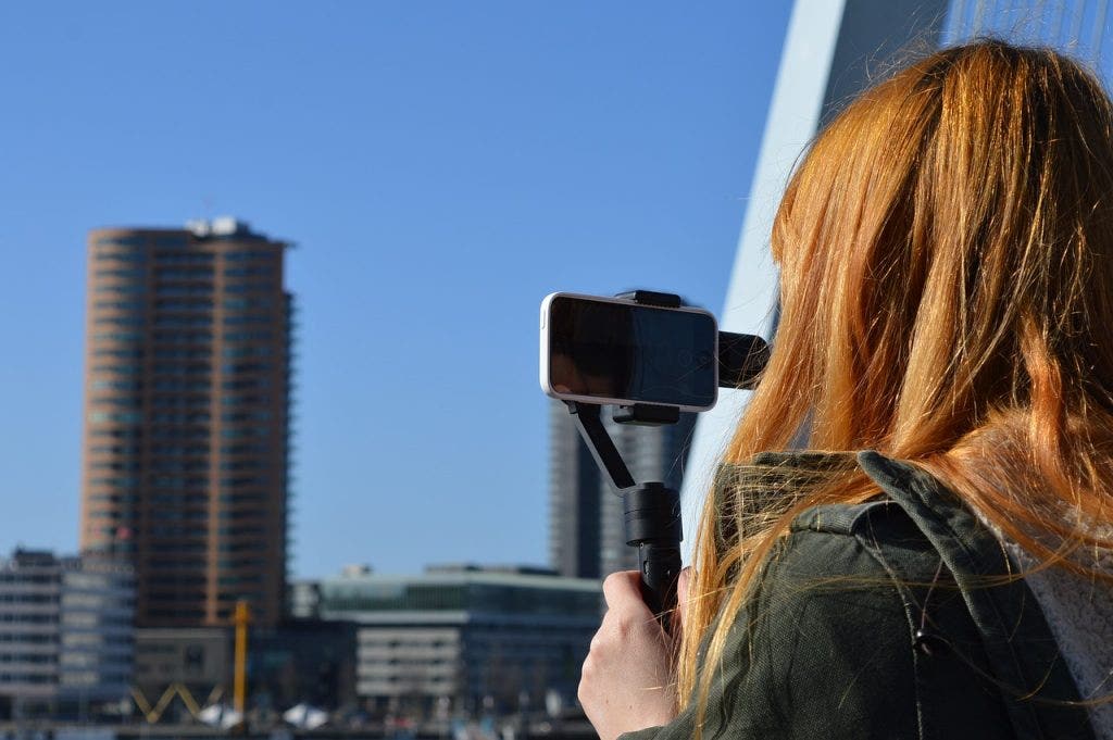 girl holding smart phone gimbal