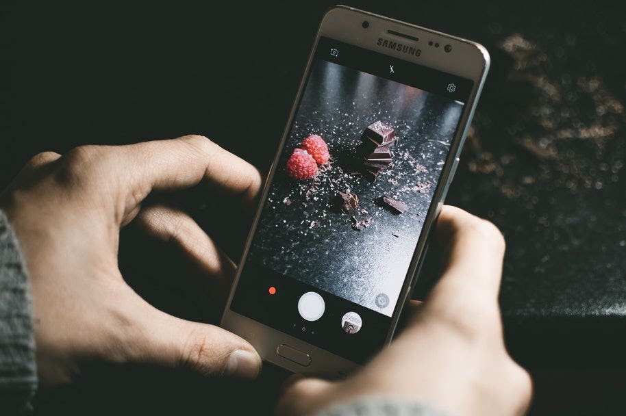 someone taking photo with phone