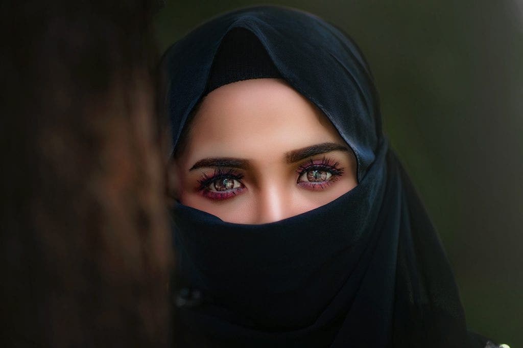 a woman with bright eyes wearing a hijab