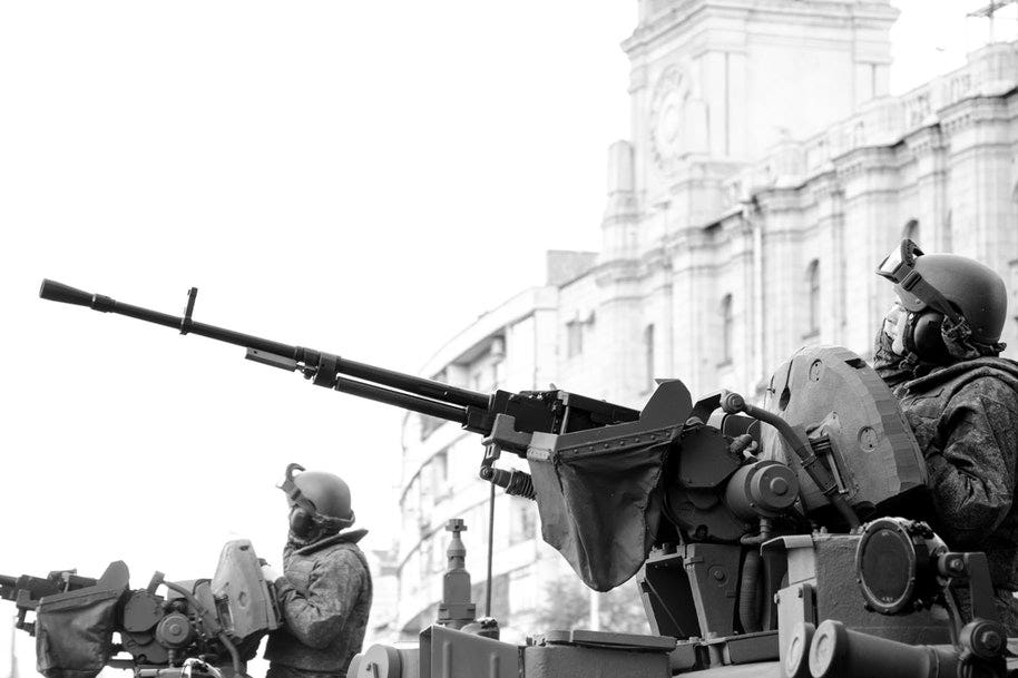 men in tanks protecting building