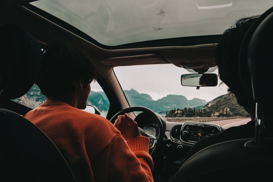driver driving car through mountains