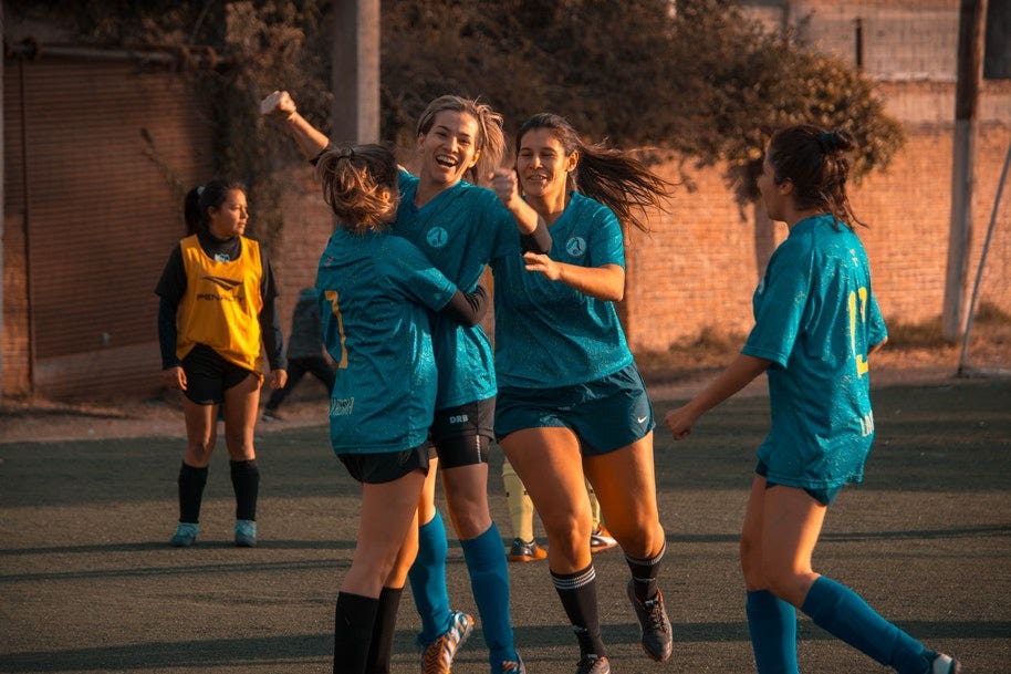 girls celebrating soccer match