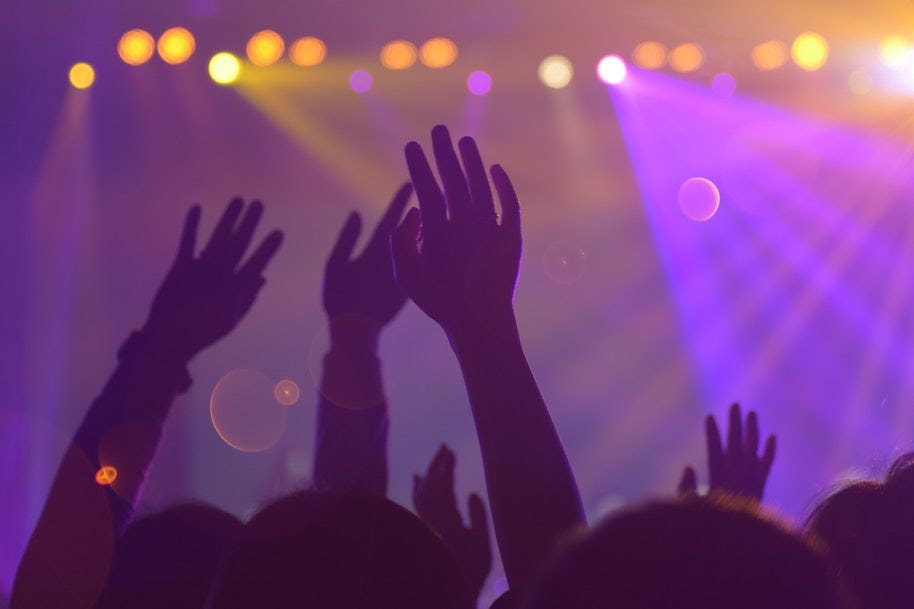 hands above crowd in night club