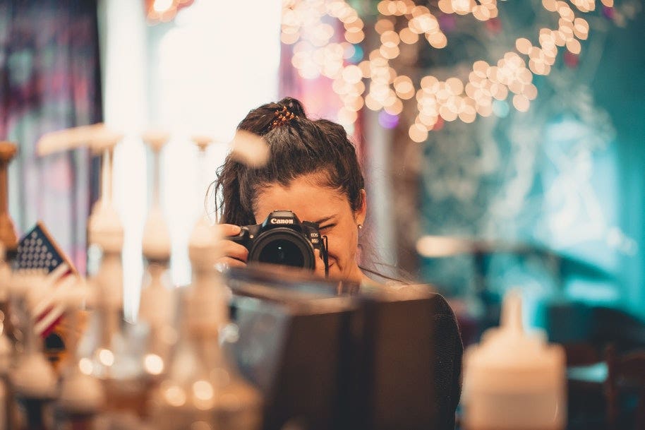 woman photographing props at party