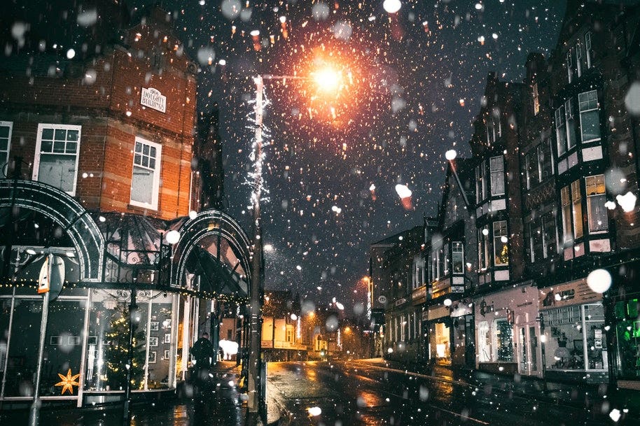 snow falling on village