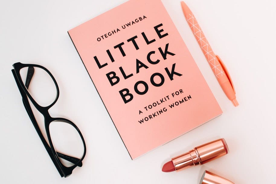 items including pen, book, glasses and lipstick on table