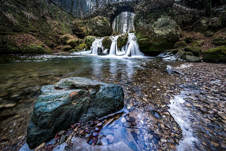 waterfall and bottom lake set amid rocks