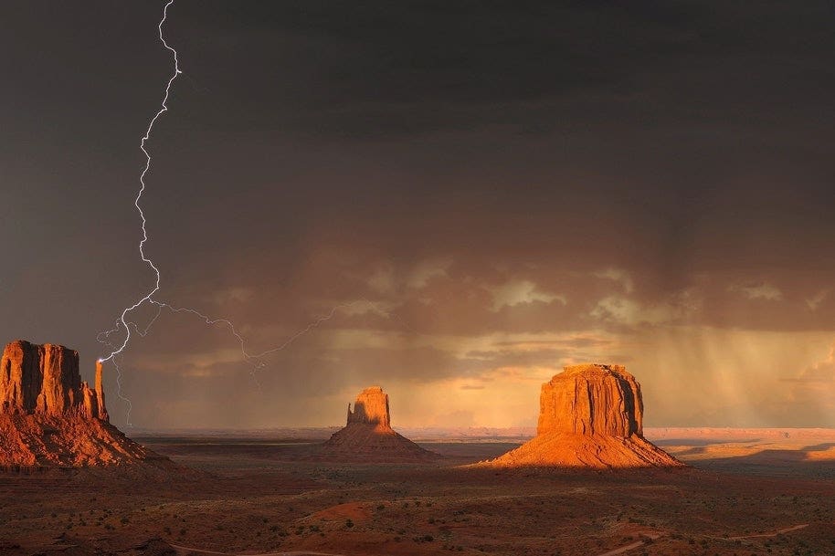 Lightning hit a rock formation in desert terrain