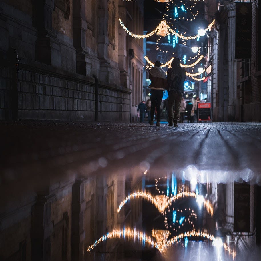 Christmas lights reflecting in a puddle